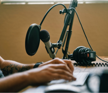 A picture of a microphone and man singing into it.